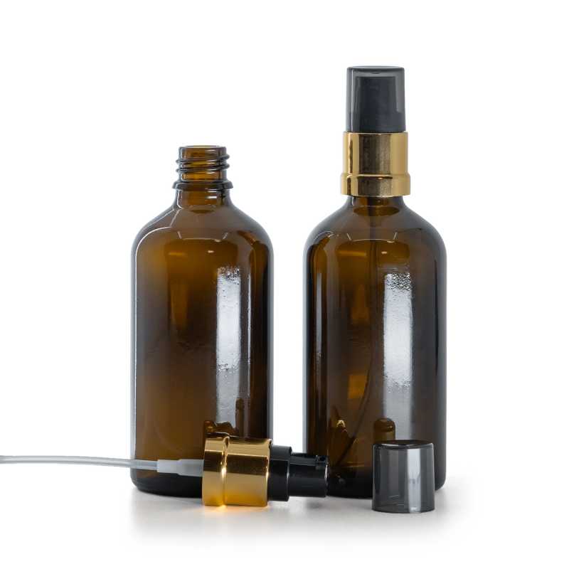 Flacon en verre brun, pompe noire et or brillante avec surcapuchon fumé, 100 ml