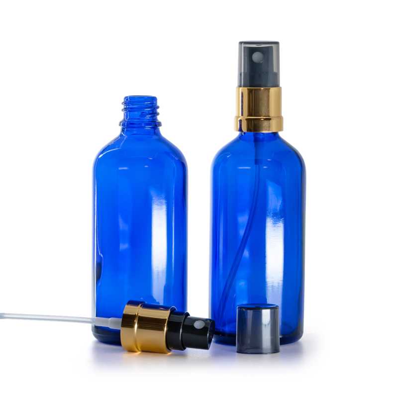 Flacon en verre bleu, pulvérisateur noir et or brillant, capot fumé, 100 ml