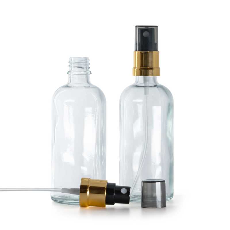 Flacon en verre transparent, pompe spray noire avec bague dorée, capot fumé, 100 ml