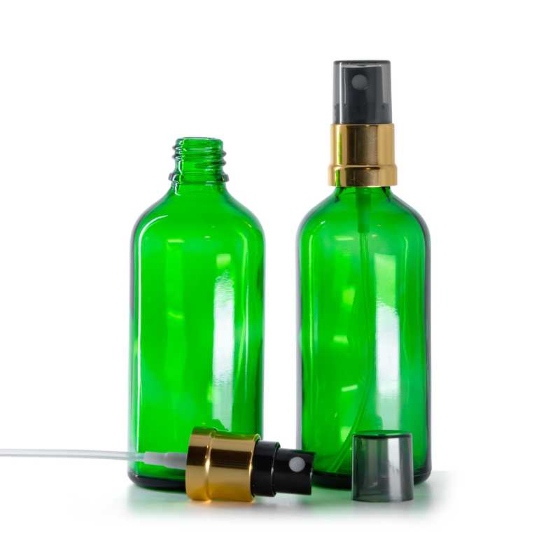 Flacon en verre vert, vaporisateur noir et or, surcapuchon fumé, 100 ml